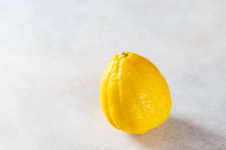 Lemon on a gray background. Unusual shape of vegetables and fruits. Yellow lemon is good for health. Horizontal orientationの写真素材