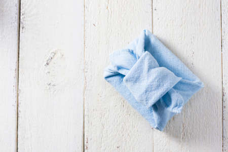 Furoshiki - traditional Japanese technique of wrapping tying items for gift. Zero waste gift wrapping. Reusable sustainable gift wrapping alternative zero waste conceptの写真素材