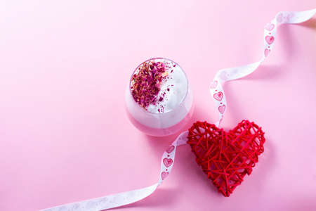 Pink Latte Tea. Pink hibiscus latte. Fashionable romantic drink. Dry flowers of roses. Pink background Copy space, flat layの写真素材