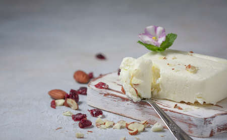 Breakfast of cottage cheese with nuts on a white wooden board. Selective focusの写真素材