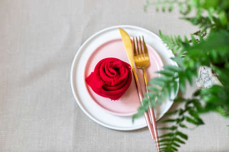 Valentines Day table setting with linen napkins, fork, knife. The concept of using environmentally friendly natural materials.の写真素材