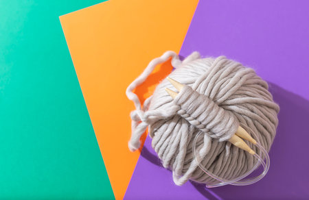 Close-up of knitting wooden knitting needles. Zero waste concept. Hobby, cozy homely weekend and...