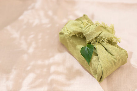 Zero waste gift wrapping traditional Japanese furoshiki style. Reusable wrapping concept. Eco...