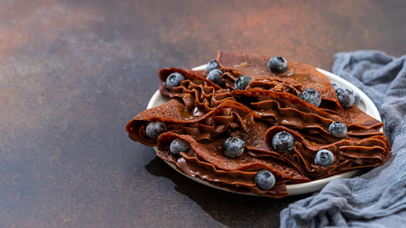 Homemade chocolate crepes with fresh berries and chocolate sauce. Selective focus, copy spaceの写真素材