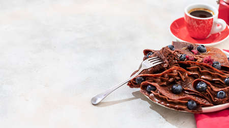 Homemade chocolate crepes with fresh berries and chocolate sauce. Selective focus, copy spaceの写真素材