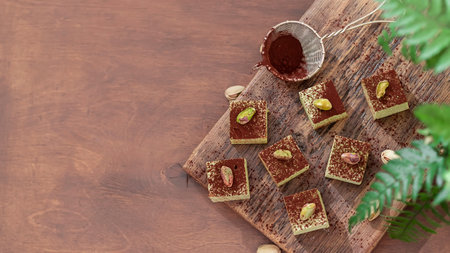 Handmade souffle candy with pistachioon a wooden background. Homemade sweets or candies. Pistachio...