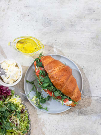 Croissant with smoked salmon and cream cheese. Close up.の写真素材