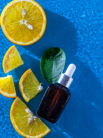 Vitamin c serum and fresh citrus fruits. Citrus essential oil. Natural cosmetics concept. SPA cosmetics with herbal ingredients. Healthy lifestyle.の写真素材