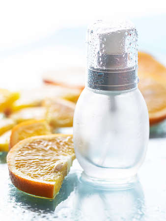 Vitamin c serum and fresh citrus fruits. Citrus essential oil. Natural cosmetics concept. Organic cosmetics. Healthy lifestyle.の写真素材