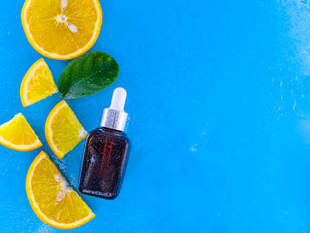 Vitamin c serum and fresh citrus fruits. Citrus essential oil. Natural cosmetics concept. Organic cosmetics. Healthy lifestyle.の写真素材