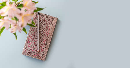 Flat lay of blue working table background with planner, pencil, and plants. Top view, mock up greeting card, craft Notebook and pen.Top viewの写真素材