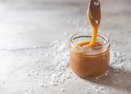 Homemade salted caramel in a glass jar. Selective focusの写真素材