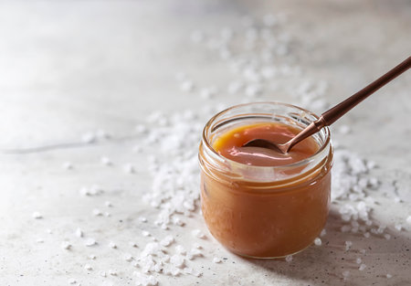 Homemade salted caramel in a glass jar. Selective focusの写真素材