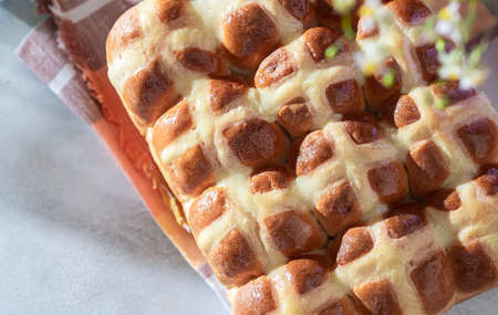 Homemade Hot Cross Buns on a light concrete background. Traditional Easter food. Easter holiday concept. British foodの写真素材