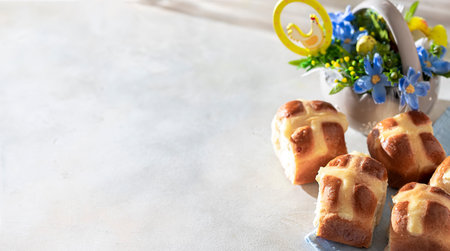 Homemade Hot Cross Buns on a light concrete background. Traditional Easter food. Easter holiday...