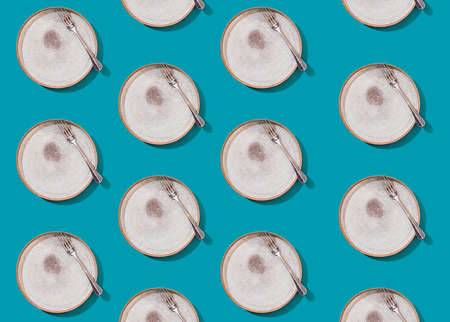 Empty plate and fork on a bright beautiful background, seamless pattern. Modern stylish design. Concept for menu with cutlery.の写真素材