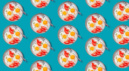 Two fried eggs with toast with avocado slicesand vegetables on colorful seamless pattern. Breakfast concept. Healthy vegetarian food. Breakfast background.の写真素材