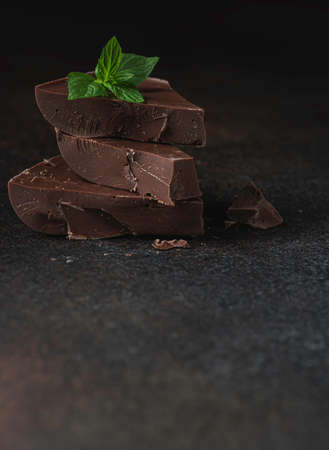 Piece chocolate with mint on a dark background. Selective focusの写真素材