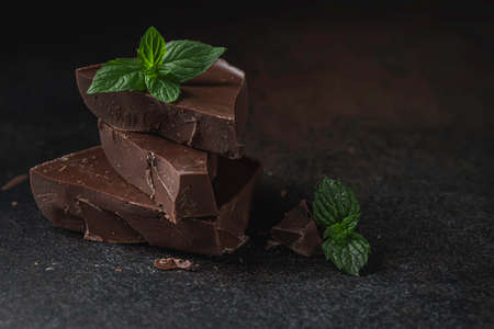 Piece chocolate with mint on a dark background. Selective focusの写真素材