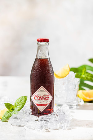 Coca-Cola Specialty Apple, Elderflow, 250 ml. Photo of a bottle with water drops. Selective focus