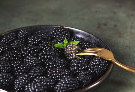 Fresh ripe blackberries as background, top view. Food concept. Blackberries decorated with edible gold powder. The concept of luxury is extraordinary. Top view.の写真素材