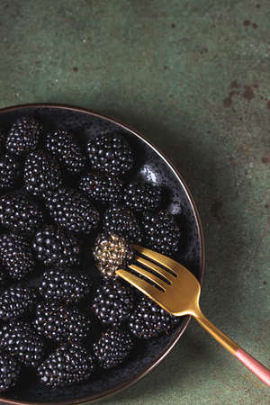 Fresh ripe blackberries as background, top view. Food concept. Blackberries decorated with edible gold powder. The concept of luxury is extraordinary. Top view.の写真素材