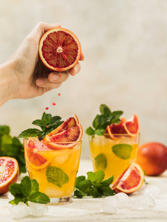 Fresh orange juice in a glass with splashes and drops. Summer refreshing and healthy dessert. copyspace.の写真素材