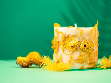 Soy candle handmade with flowers. Beautiful handmade candle. Relaxation atmosphere. Luxurious lifestyle. selective focusの写真素材