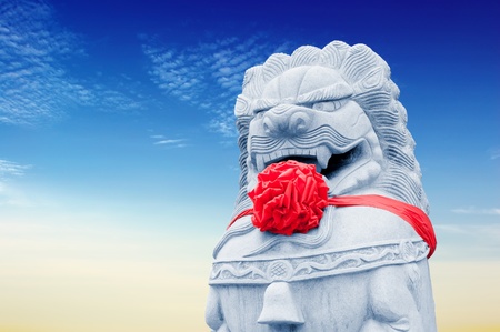 Dressed in red silk with stone lionsの写真素材
