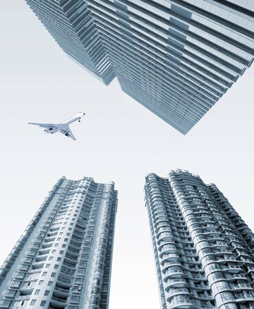 Airplane over the cityï¼High-rise buildings.の写真素材