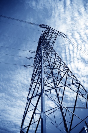 Electricity pylon against blue cloudy skyの写真素材