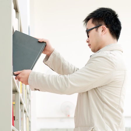 Handsome men in the selection of their favorite library booksの写真素材