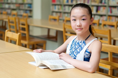 Pretty girls reading in the library, very serious study.