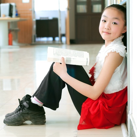 Pretty girls reading in the library, very serious study.の写真素材