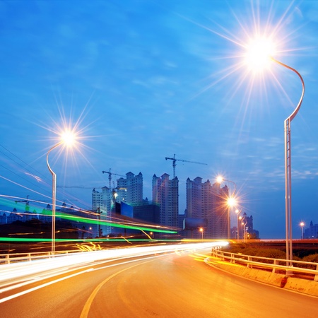 Highway light trails, modern city at night の写真素材