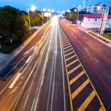 Highway light trails, modern city at night 