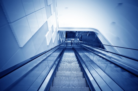 Blue color of the escalators, modern building interiors の写真素材