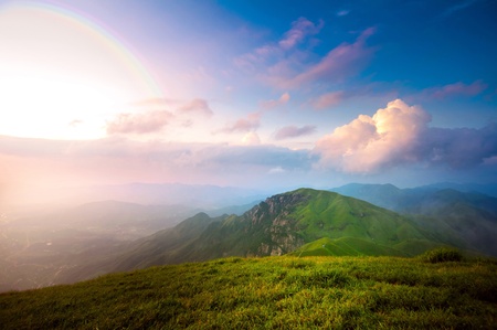 majestic sunset clouds and path through a mountain meadow to horizon
の写真素材