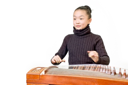 Girl, are practicing playing zither の写真素材