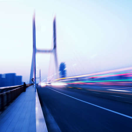 cars light trails on the modern bridge at duskの写真素材