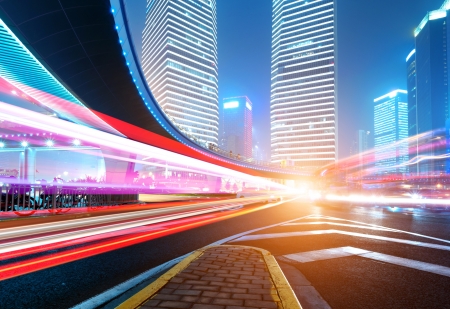 The light trails on the modern building background in shanghai china.の写真素材