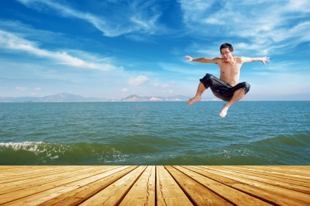 Man jumping on a tropical beachの写真素材