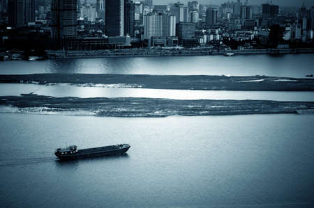 Dusk, the city's river, a boat slowly passed.の写真素材