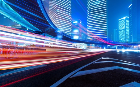 The light trails on the modern building background in shanghai china の写真素材