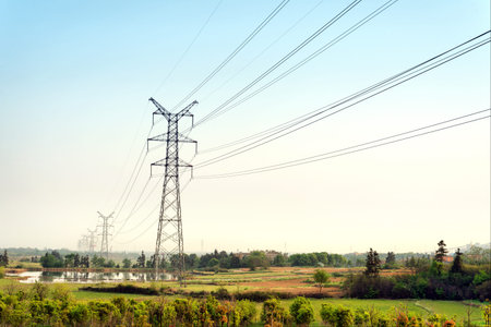 Electricity pylon against blue cloudy sky