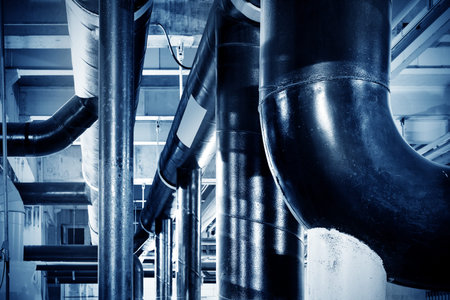 Equipment, cables and piping as found inside of industrial power plant