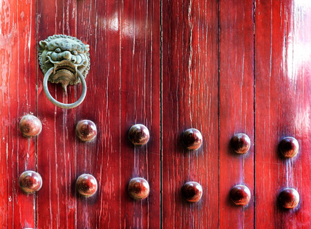 Red chinese door with a lion/dragon head. Concept: Chinese New Year celebration.の写真素材