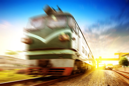 Train passing by in orange sunset