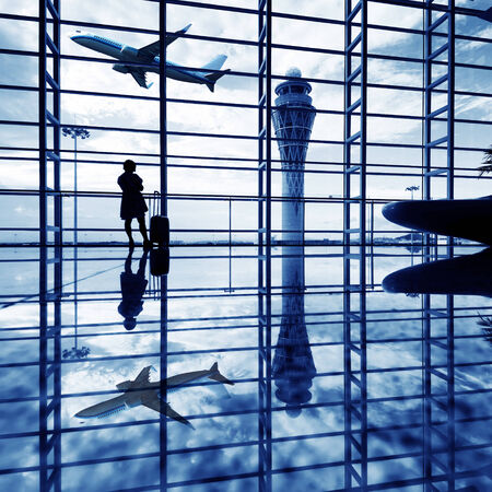 girl at the airport window and flight departureのeditorial素材