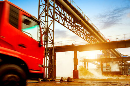 Steelworks pipes and trucks, twilight landscape.の写真素材